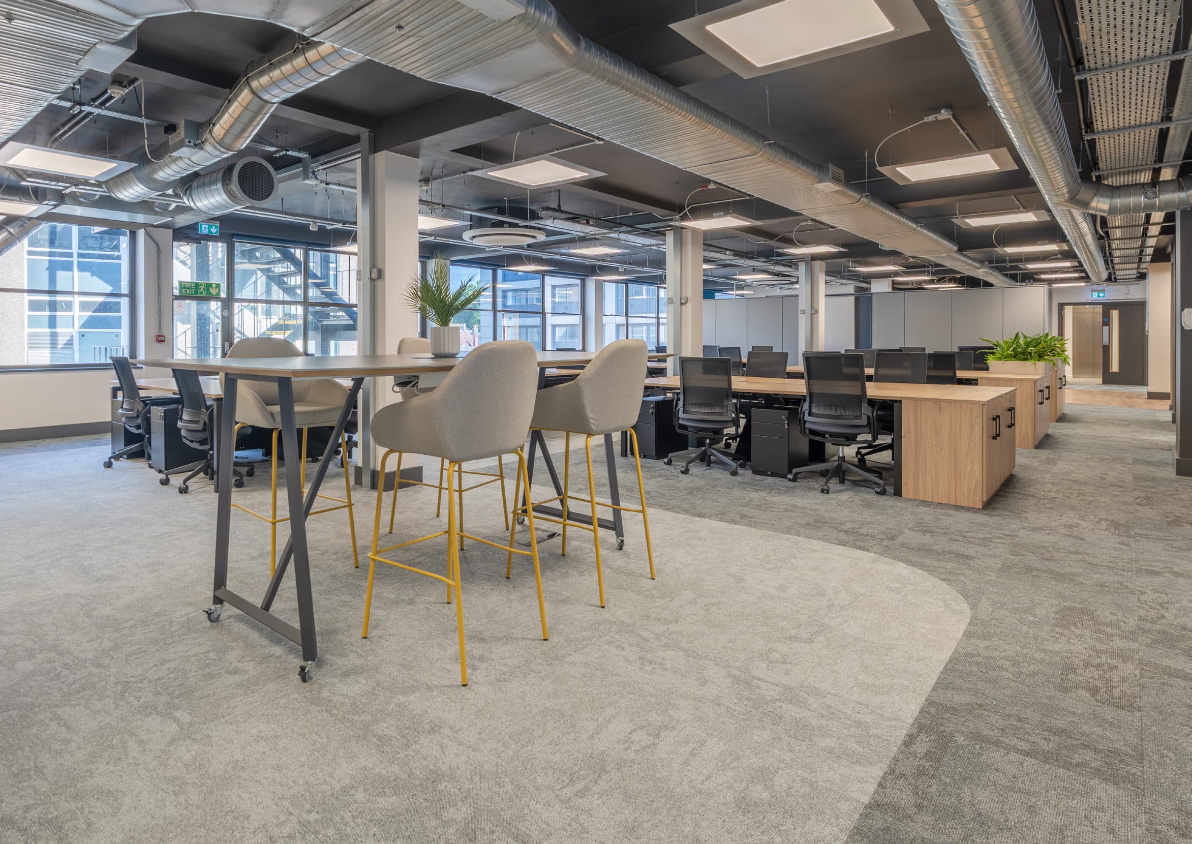 Remodelled open-plan office space with high stools and desks